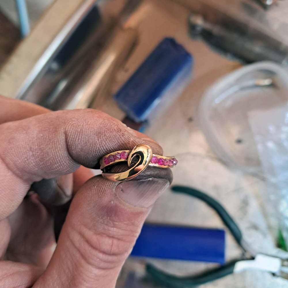 Après : Bague en or à rubis tenue par le joaillier